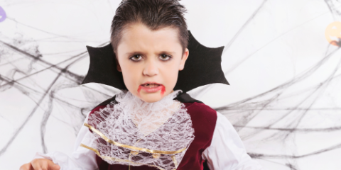 Kid in a vampire costume