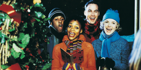 multi-racial couples singing christmas carols