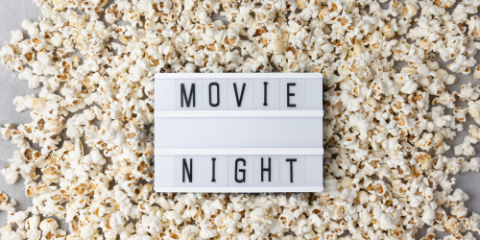 'movie night' sign on a bed of popcorn