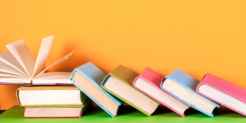 cascade of books on an orange background