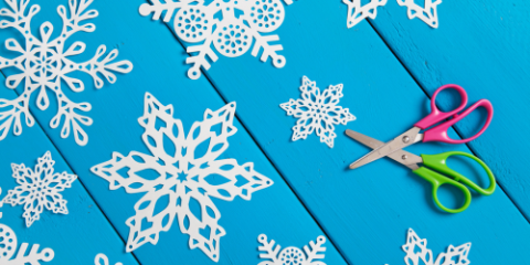 paper snowflakes on a blue table