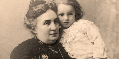 Old photo of a woman holding a child, sepia image