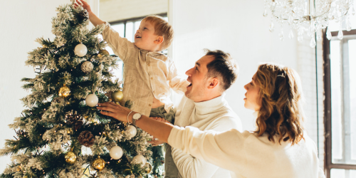 a family decorating a christmas tree