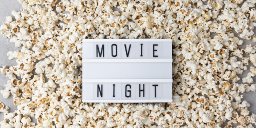 'movie night' sign on a bed of popcorn